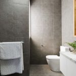 75761268 - charcoal grey modern bathroom with marble benctop and wood mirror